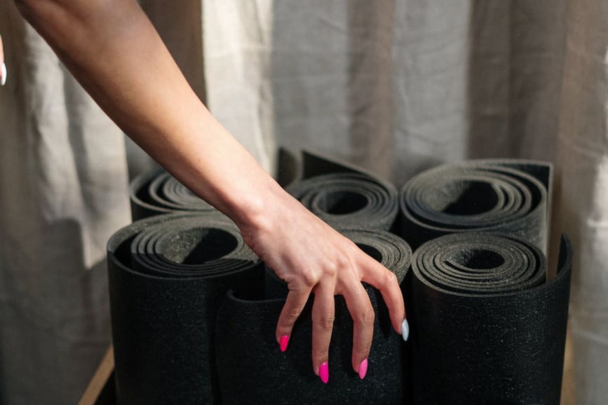 Close up of a person hands on a yoga mat.